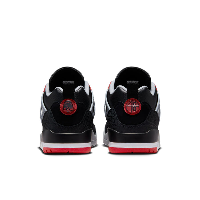 Men's black low-top sneakers, rear view with red heel tabs and gray sole