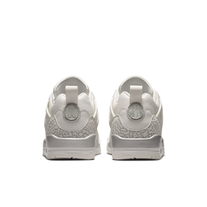 White low-top sneakers with textured heel panels and light gray outsole