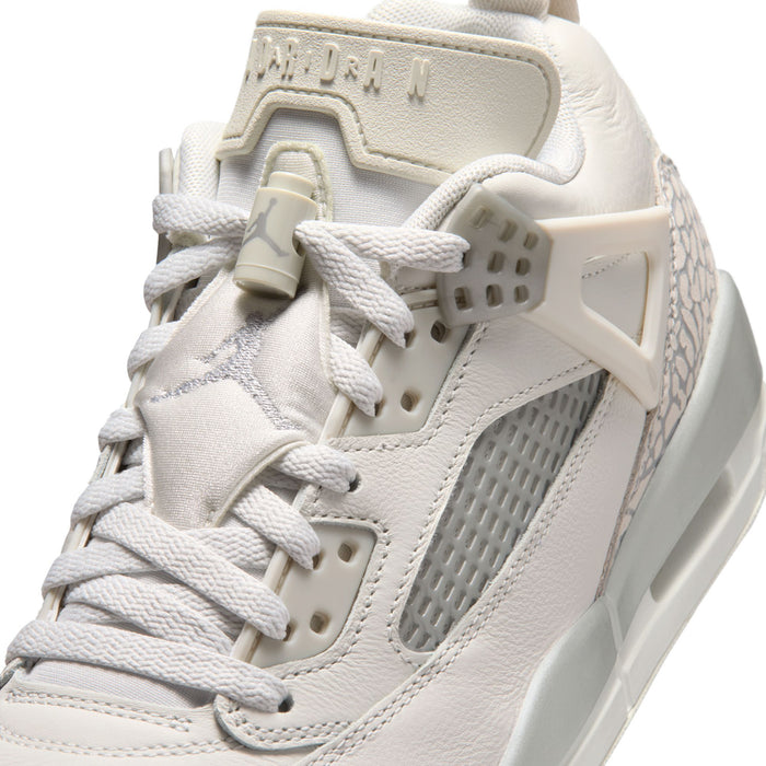 White low-top sneaker with lace-up, gray mesh, and textured heel overlay