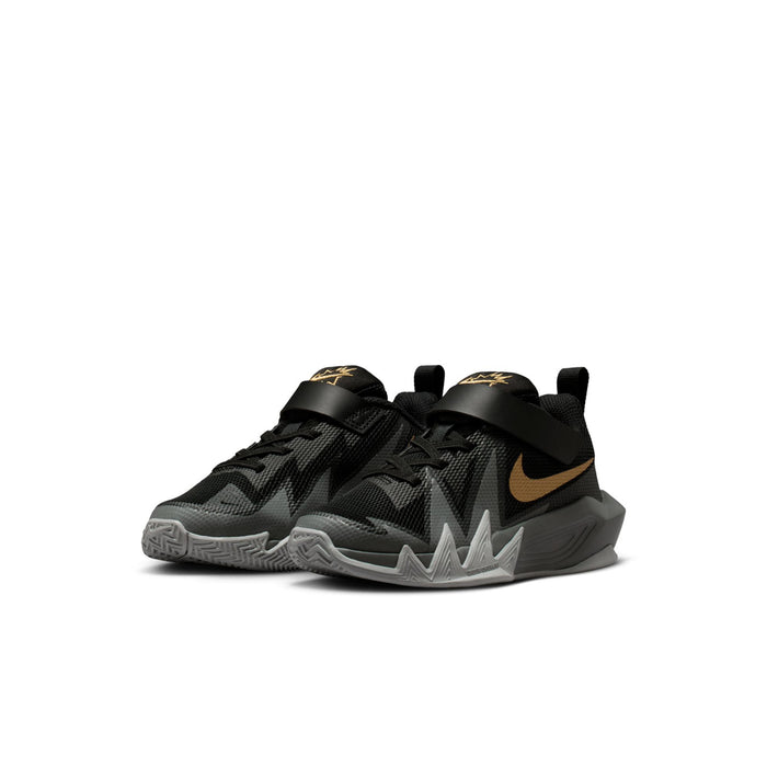 Kids black and gray sneakers with gold swoosh accents and Velcro strap detail