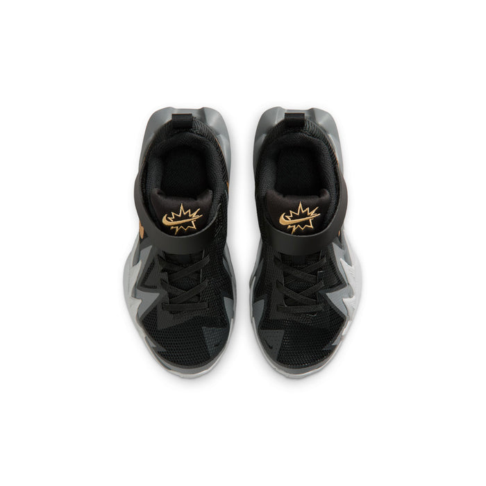 Kids black sneakers front view with gold logo on heel collar and padded tongue