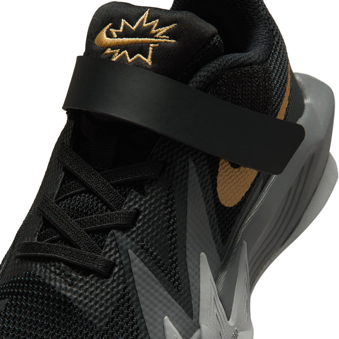 Kids black sneaker upper close-up with gold logo on collar and wide Velcro strap
