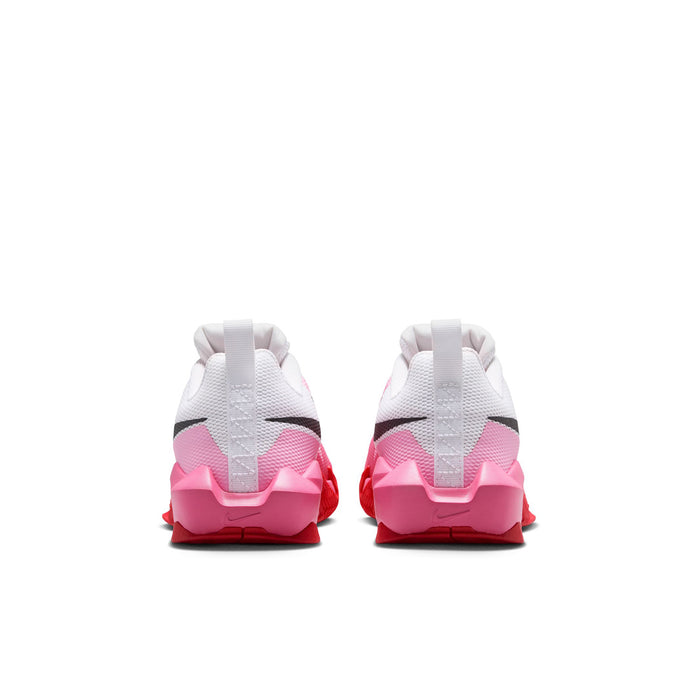 Youth sneakers viewed from heel: white upper with pink accents and textured rubber sole