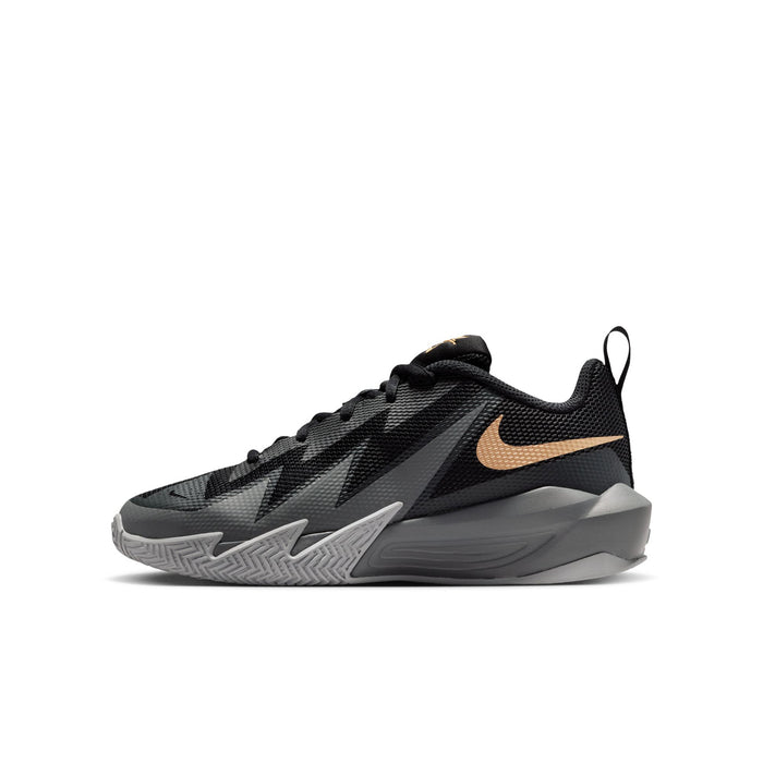 Youth basketball shoe, angled side view, black with gold swoosh and gray midsole