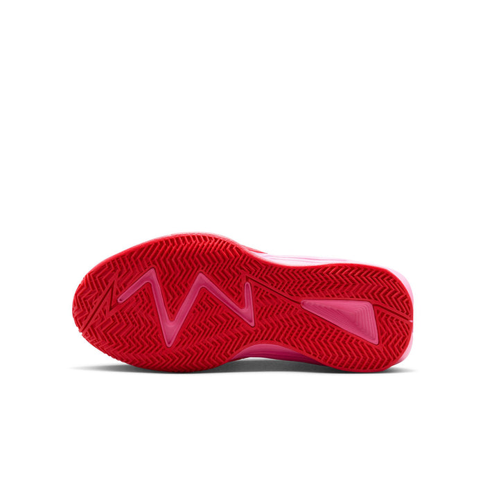 Bottom view of youth sneakers with red rubber traction sole and patterned grip