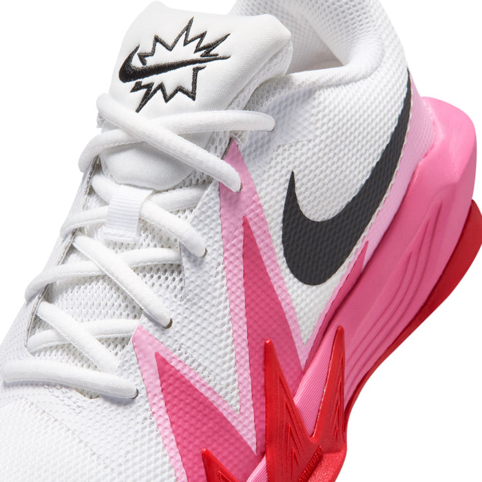 Close-up youth sneaker upper: white mesh, black swoosh, pink lightning on side