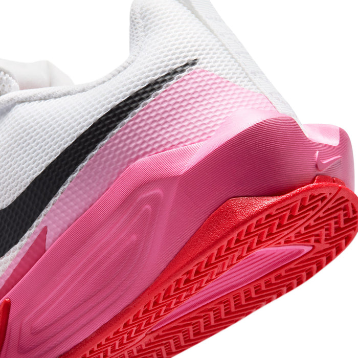 Close-up youth sneaker side: pink midsole with red patterned outsole and black trim