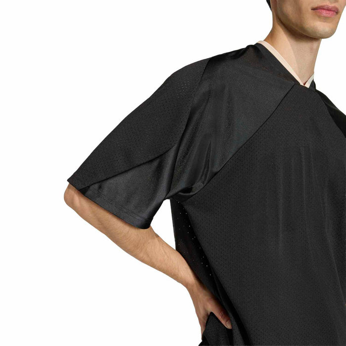 Black mesh tee sleeve and shoulder detail with textured fabric and raglan seam