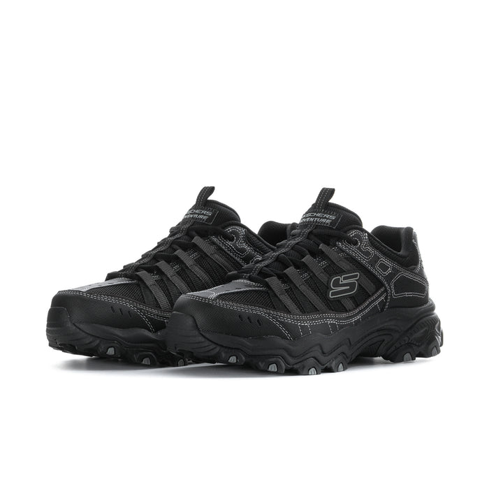 Men's black athletic sneakers, side view with S logo and textured panel details