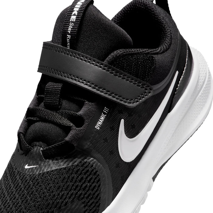 Kids black sneaker detail: dynamic lace strap, white swoosh, textured upper