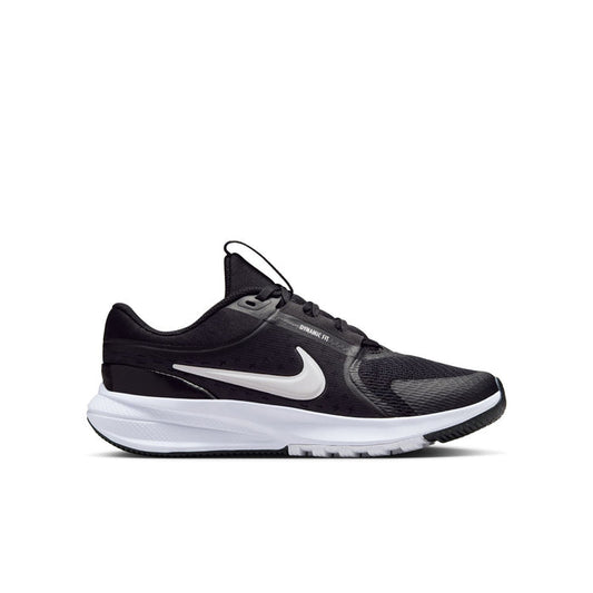 Youth black running shoe with white Nike swoosh and white cushioned sole