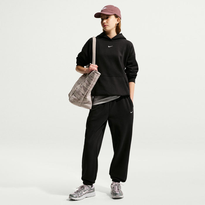 Youth black fleece loose sweatpants with elastic waistband, cuffed ankles, and Nike logo