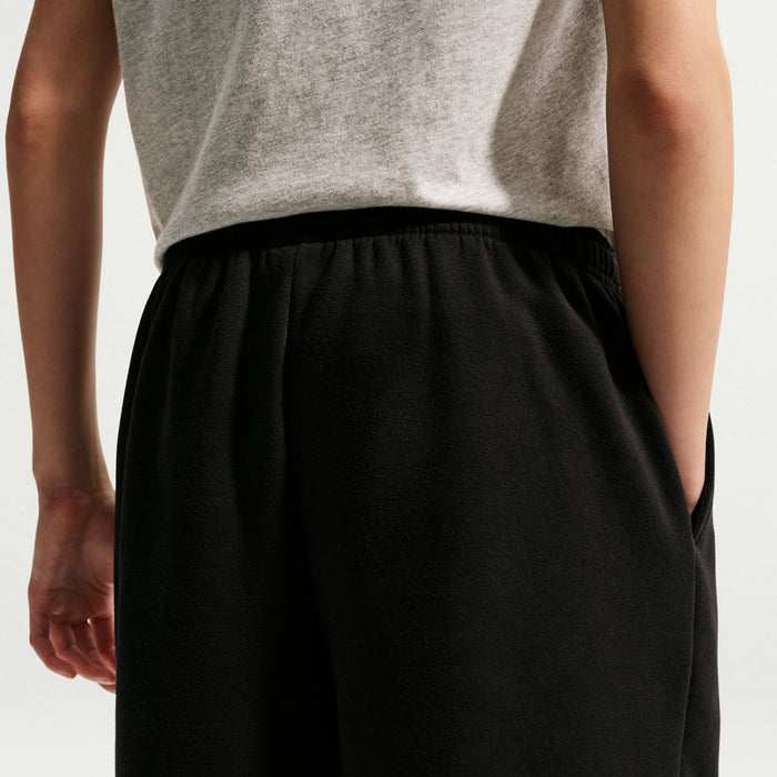 Youth black fleece loose pants with elastic waistband and relaxed upper-leg fit