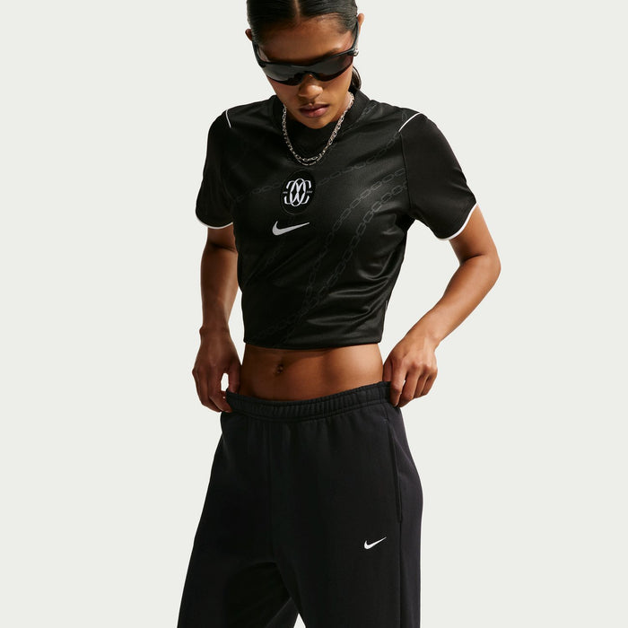 Women's black fleece pants with elastic waistband and visible drawstring, side logo
