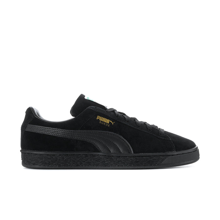 Black suede low-top sneakers with lace-up, Puma logo, and textured rubber sole.