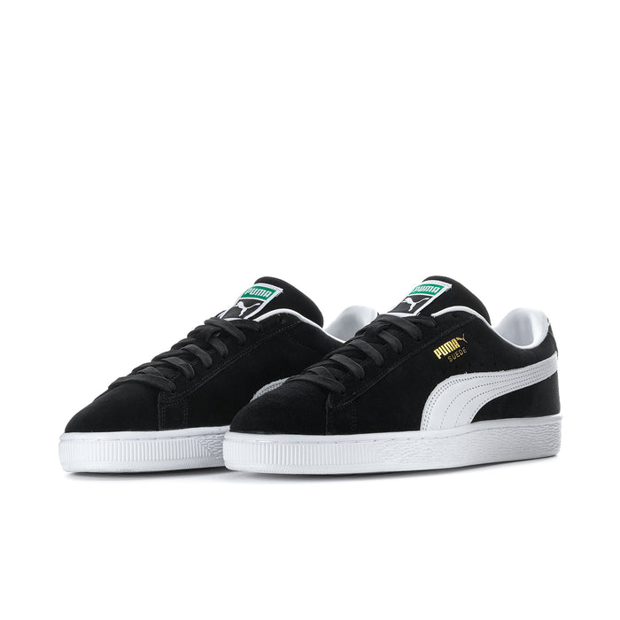 Black suede low-top sneakers, side view, white midsole and Puma logo details