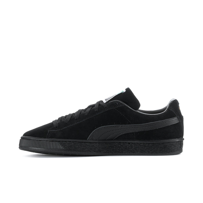 Black suede low-top sneakers side view with lace-up and Puma stripe detail.