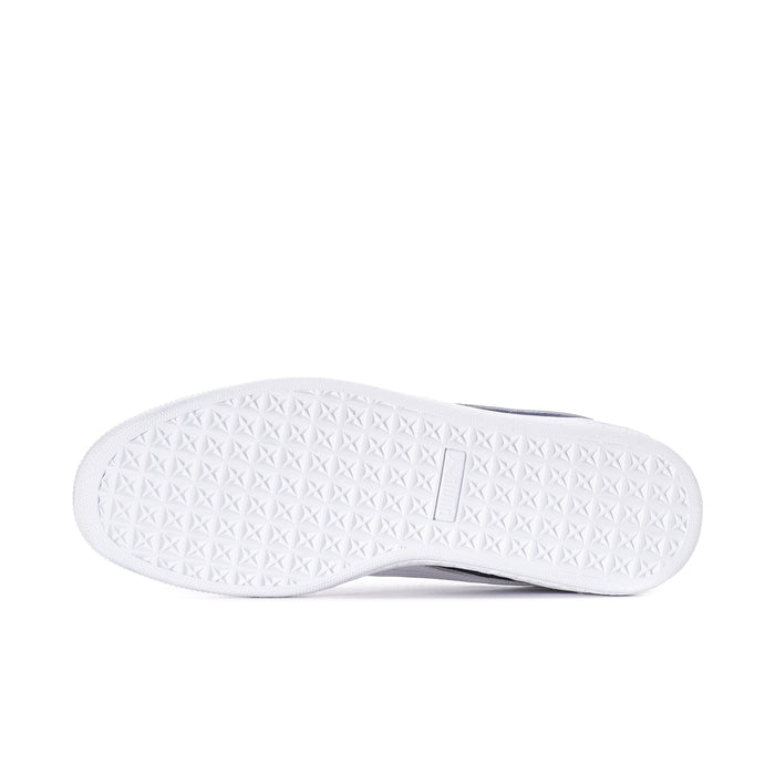 White textured outsole of a navy suede low-top sneaker with Puma mark