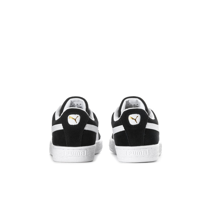 Youth black suede sneakers with white heel trim and Puma logo on back