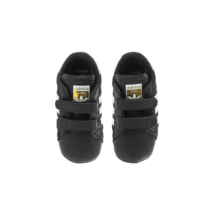 Infant black adidas Superstar sneakers, heel view with adidas logo and straps