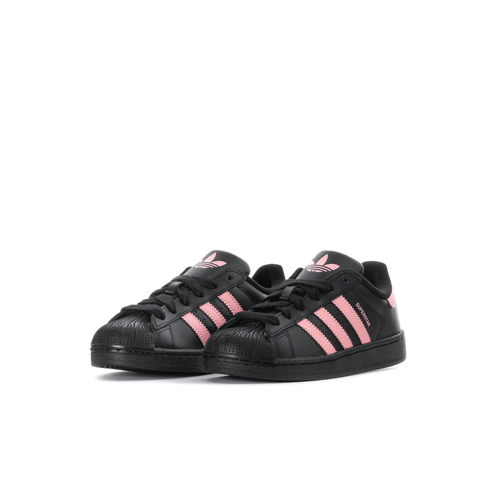 Kids' adidas sneakers, black low-top with pink stripes and lace-up closure