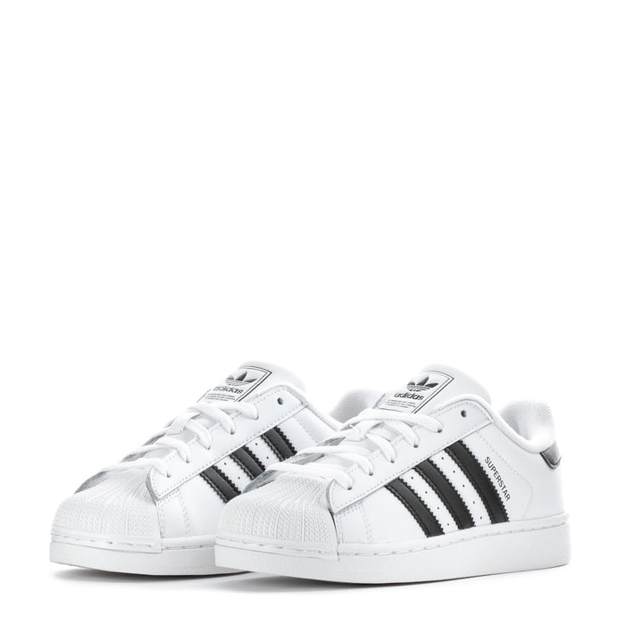 Kids' adidas low-top sneakers, front pair view in white with black three-stripe details