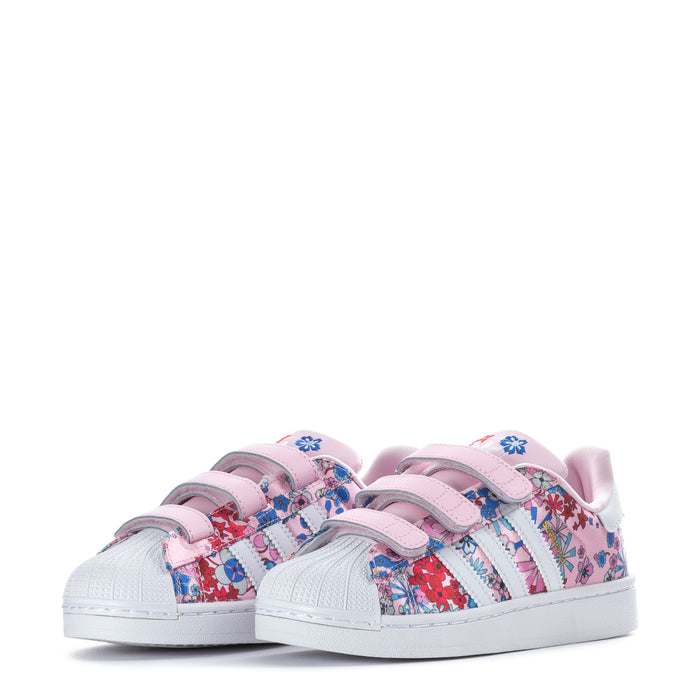 Pair of kids' Superstar-style sneakers with pink floral uppers and white stripes