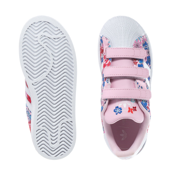Kids' sneakers shown sole and side: pink straps, floral fabric, white tread