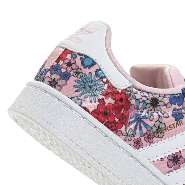Kids' sneaker toe and side close-up with floral print, pink collar, and adidas logo