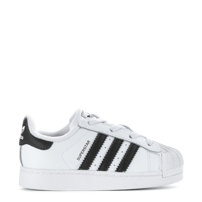 Toddler white and black striped sneakers with lace-up front and rubber sole