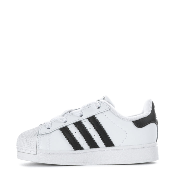 Toddler white sneakers with black stripes, lace-up closure, and side branding