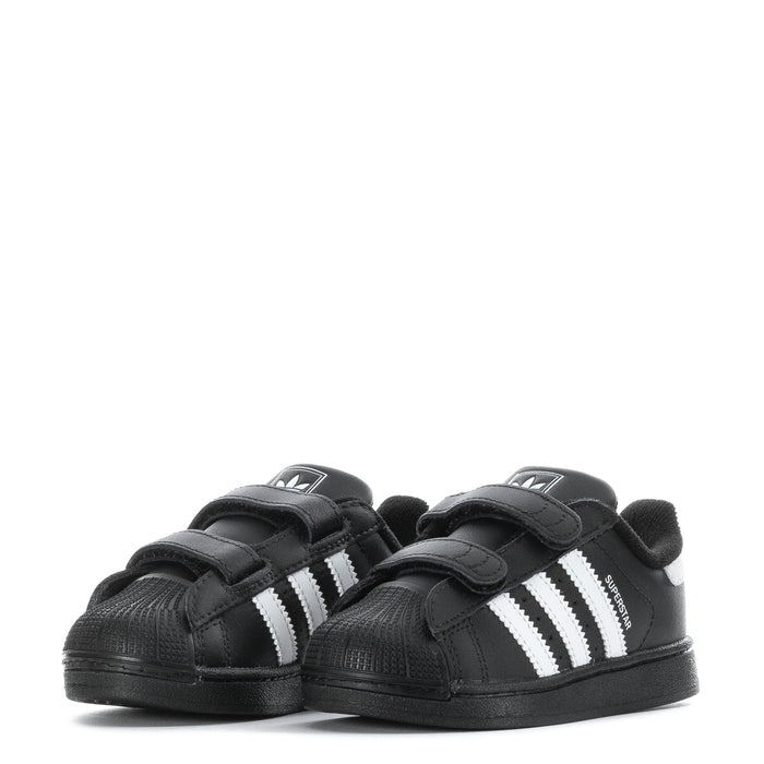 Toddler black sneakers with white triple stripes and two Velcro straps, pair view