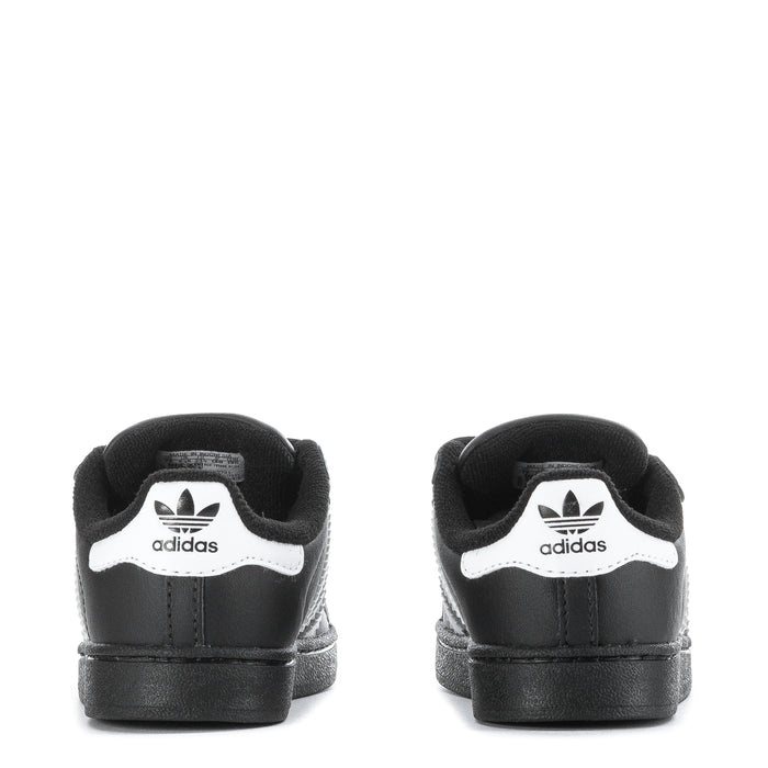 Toddler black sneakers with white adidas logo on heel and Velcro closure