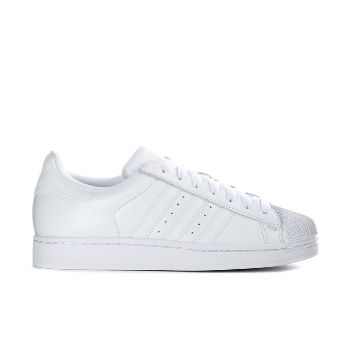 White low-top womens sneakers with three side stripes and lace-up closure