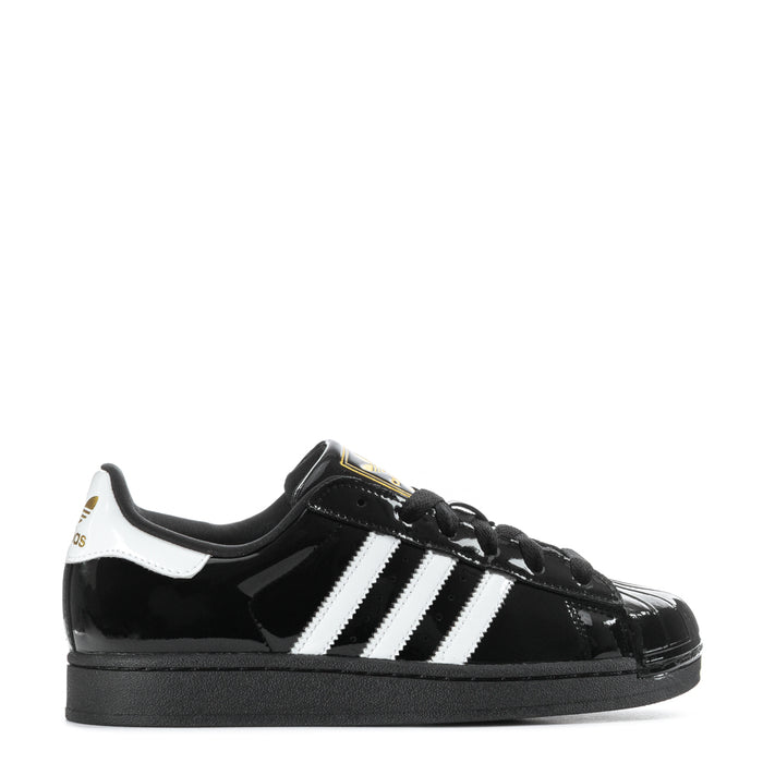 Women’s black patent leather sneaker with white three-stripe sidewall and black laces