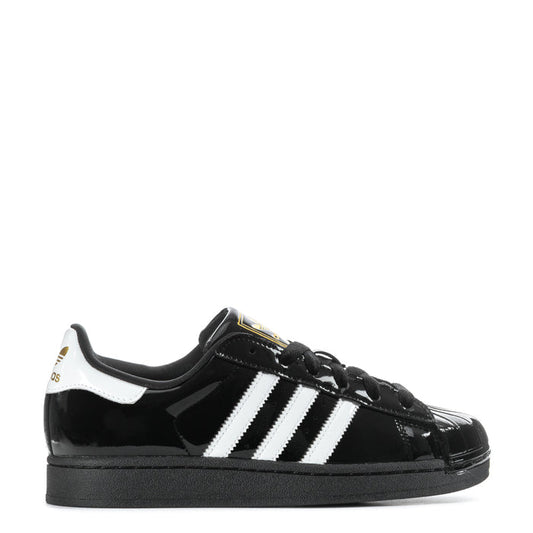 Women’s black patent leather sneaker with white three-stripe sidewall and black laces