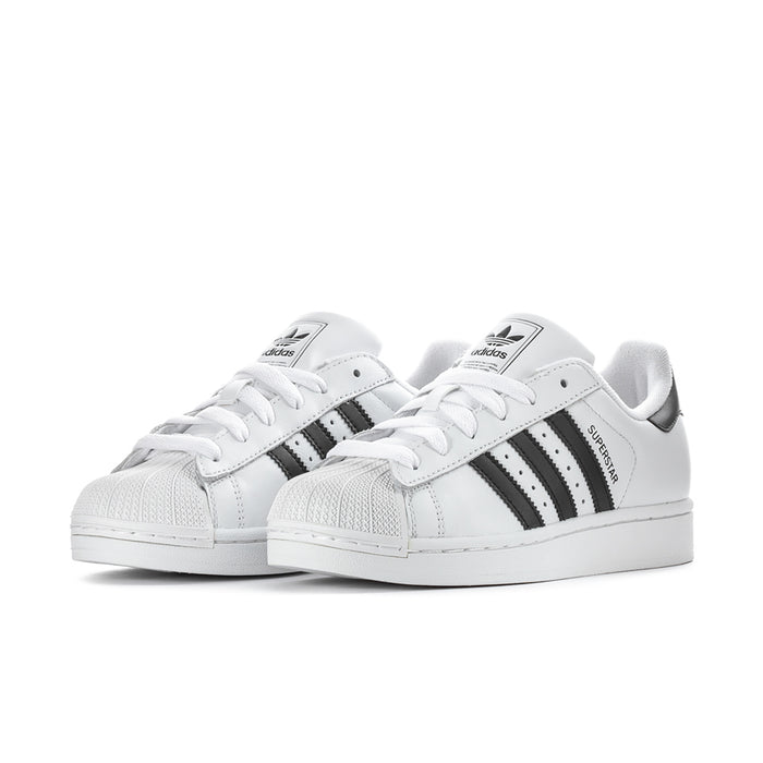 Pair of women's white low-top sneakers with black stripes and white laces
