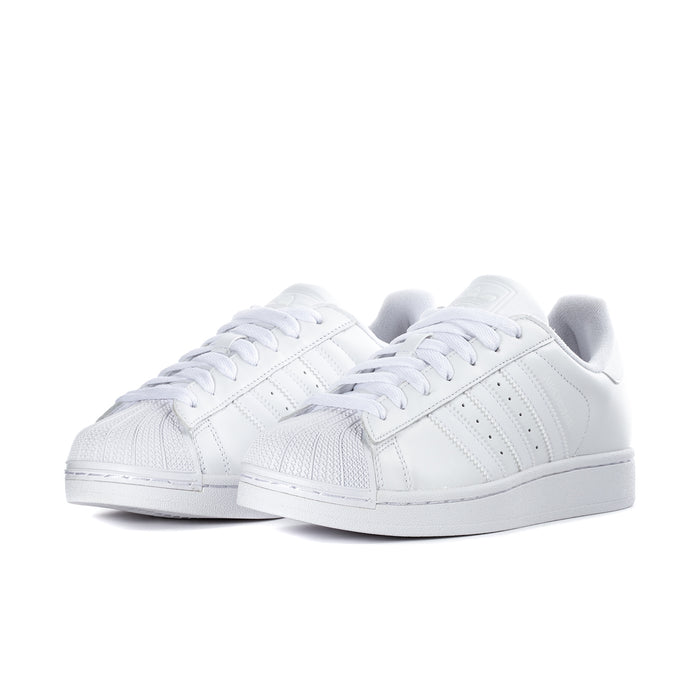 Pair of white womens low-top sneakers with lace-up front and rubber shell toe