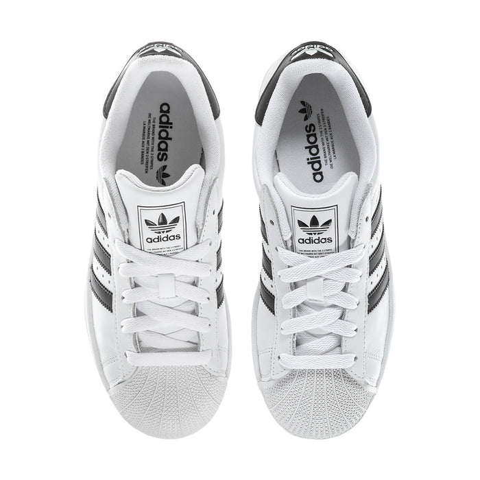 Women's white sneakers with black accents, lace-up front and adidas logo on tongue
