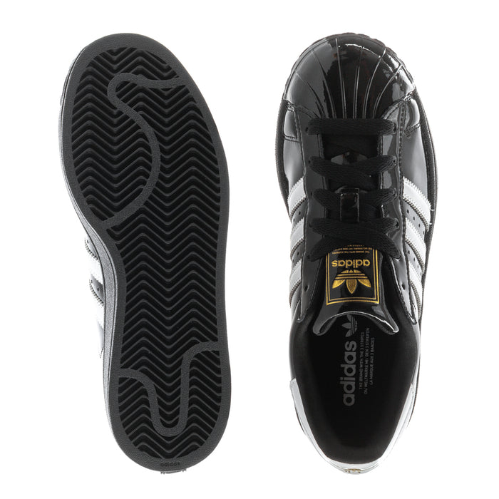Women’s sneaker sole and side view: black rubber outsole with tread pattern