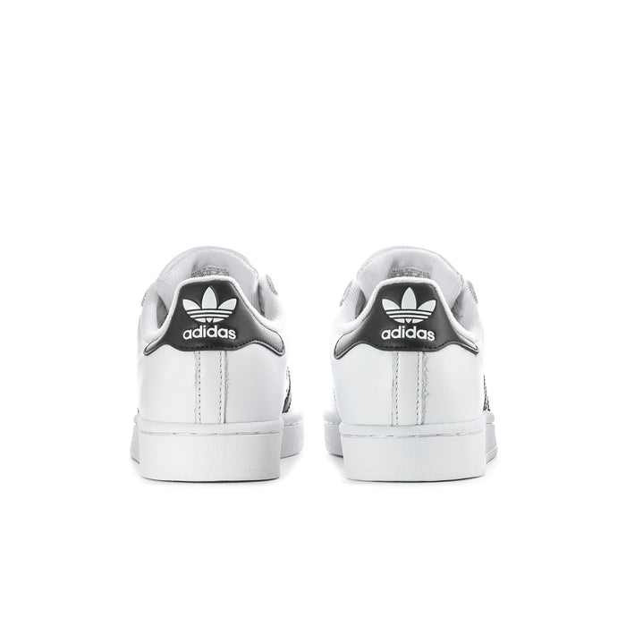 Women's white low-top sneakers, rear view with adidas trefoil on heel tab