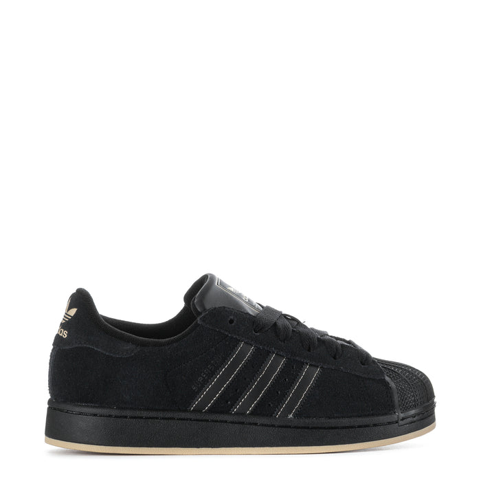 Youth black low-top sneakers with three-striped design and lace-up closure.