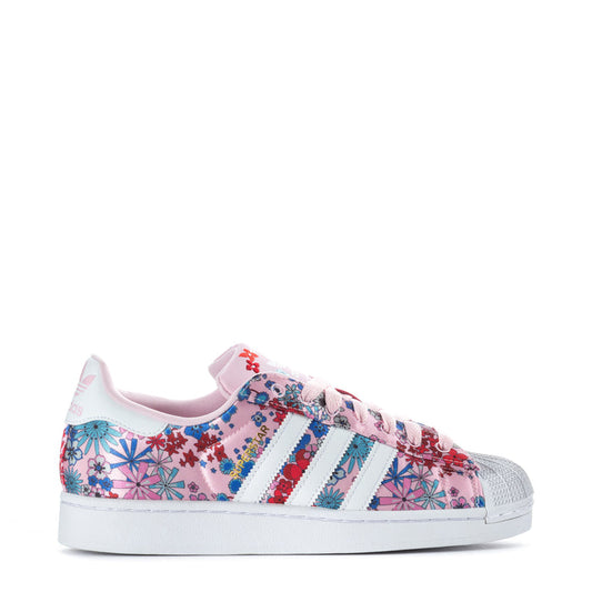 Youth floral lace-up sneaker with white three stripes and pink toe cap.