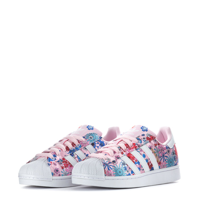 Youth floral low-top sneakers, pink patterned uppers with white rubber cupsole.