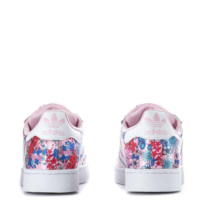 Youth sneaker heel view, pink floral fabric with adidas logo on white heel tab.