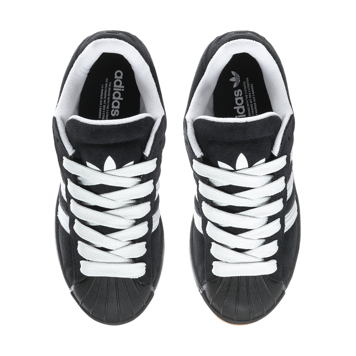 Black and white men's low-top sneakers with white laces and adidas logo on tongue.