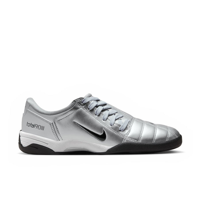 Metallic silver women's soccer sneaker with black sole and black swoosh.