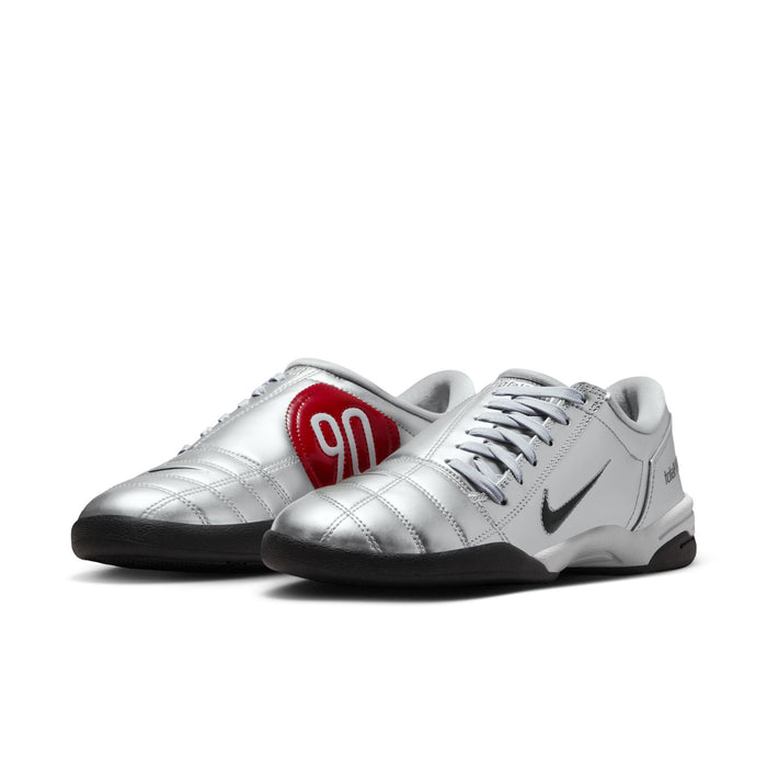 Metallic silver lace-up sneaker with red 90 tongue patch and black outsole.