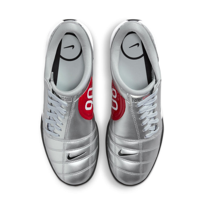 Metallic silver lace-up sneakers with red 90 tongue and black Nike swoosh.