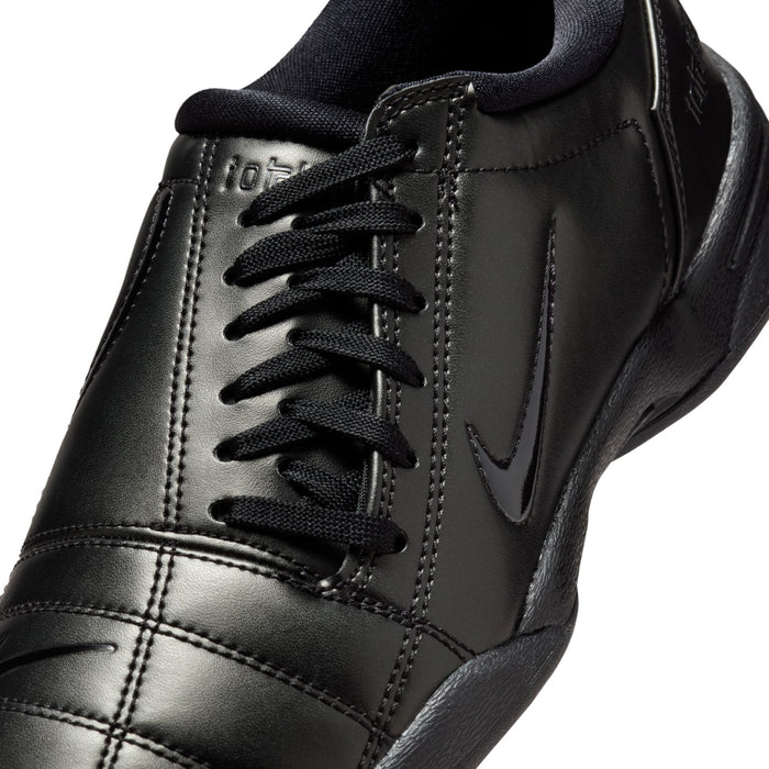 Close-up of women's black Nike lace-up sneakers with stitched leather panels
